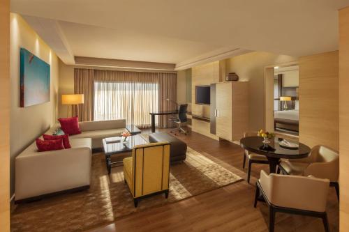 a living room with a couch and a table at JW Marriott Mumbai Juhu in Mumbai