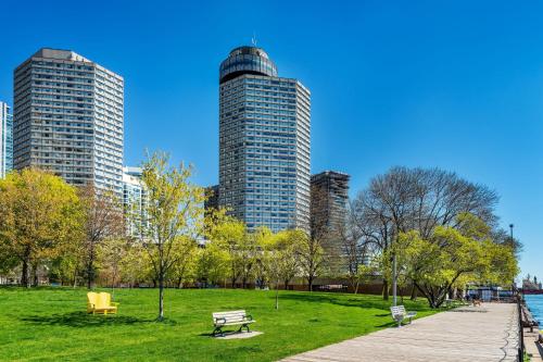 a park with two tall buildings in a city at The Westin Harbour Castle, Toronto in Toronto