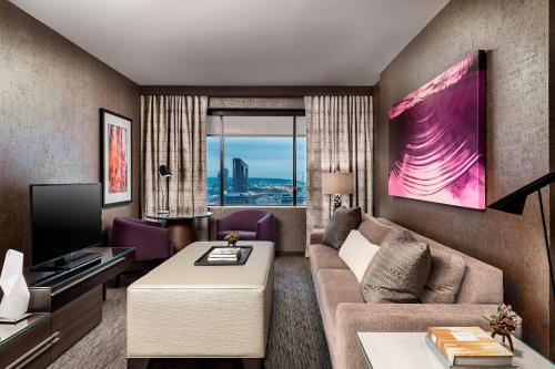 a living room with a couch and a tv at The Westin Harbour Castle, Toronto in Toronto