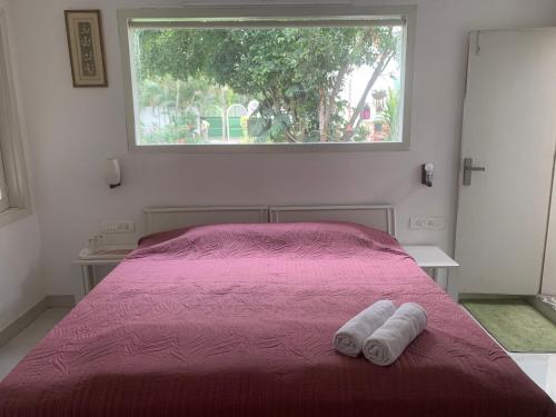 a bedroom with a bed with two towels on it at Green Serene Abode in Meerut