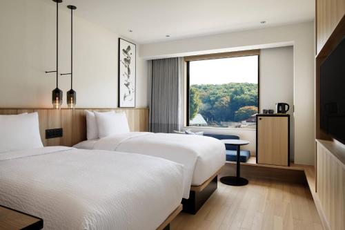 Ein Bett oder Betten in einem Zimmer der Unterkunft Fairfield by Marriott Tochigi Utsunomiya