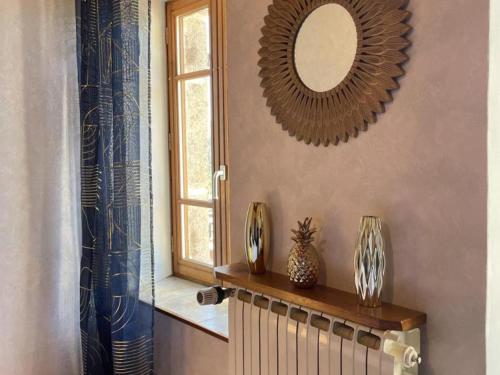 a room with a mirror and a radiator and a window at Gîte Laprugne, 3 pièces, 6 personnes - FR-1-489-448 in Laprugne