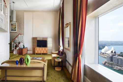 a living room with a view of the sy at Sydney Harbour Marriott Hotel at Circular Quay in Sydney