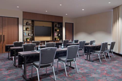 a conference room with tables and chairs and a screen at Sydney Harbour Marriott Hotel at Circular Quay in Sydney