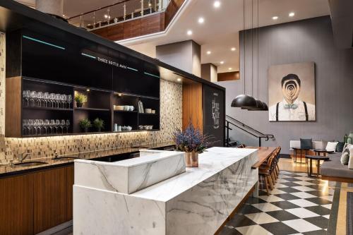 a lobby with a bar with a checkered floor at Sydney Harbour Marriott Hotel at Circular Quay in Sydney