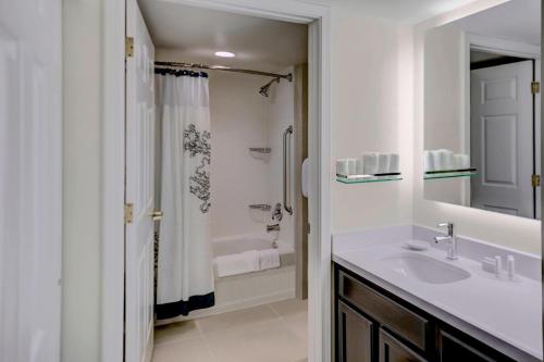 a white bathroom with a sink and a shower at Residence Inn by Marriott Cleveland Mentor in Mentor
