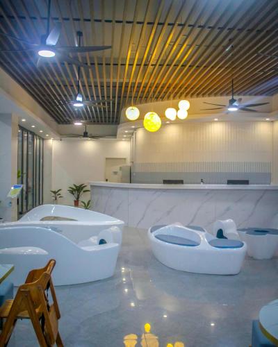 a large bathroom with two tubs and two sinks at Bohol Dolphin Bay Resort in Panglao Island