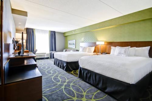 a hotel room with two beds and a television at Fairfield Inn & Suites by Marriott Guelph in Guelph