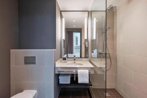 a bathroom with a sink and a shower at Residence Inn by Marriott Frankfurt City Center in Frankfurt/Main
