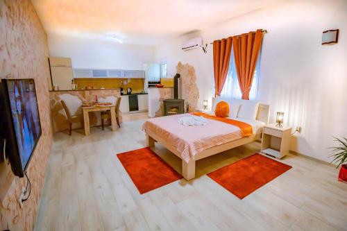 a bedroom with a large bed and a kitchen at Simo apartments airport Podgorica in Podgorica