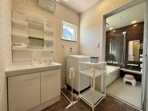 a bathroom with a sink and a tub and a toilet at SHIRAHAMA condominium D-100 in Kanayama