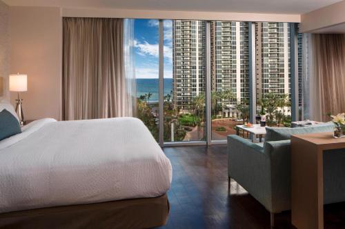 a hotel room with a bed and a large window at Residence Inn Miami Sunny Isles Beach in Miami Beach