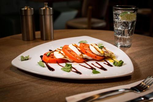 a white plate with food on a wooden table at Residence Inn Miami Sunny Isles Beach in Miami Beach