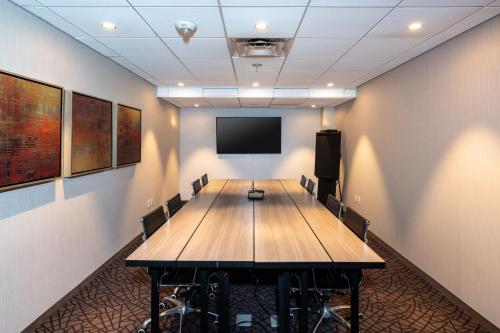 a conference room with a wooden table and a flat screen tv at Residence Inn by Marriott at Anaheim Resort/Convention Center in Anaheim