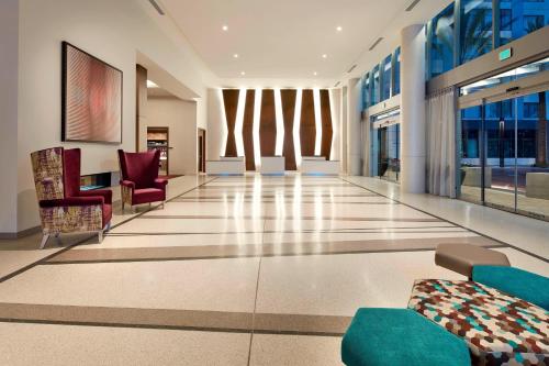 a lobby with chairs and a couch in a building at Residence Inn by Marriott at Anaheim Resort/Convention Center in Anaheim