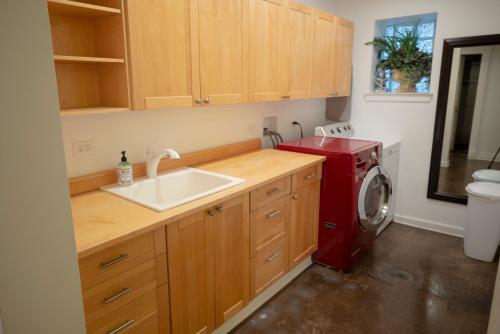 a kitchen with a sink and a washing machine at Inspiring Grotto Sleeps 10-20 Free TV & Parking in Chicago