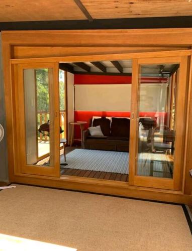 a room with a glass door with a living room at Francis Lane Tiny Studio in Adventure Bay
