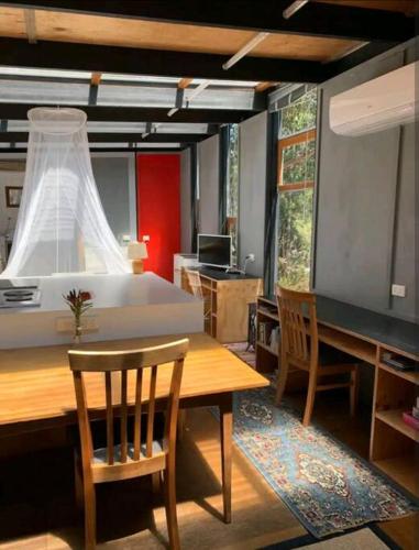 a room with a table and chairs and a bed at Francis Lane Tiny Studio in Adventure Bay