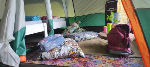 a group of pillows sitting inside of a tent at Jungle Glamping Tent in Maluk
