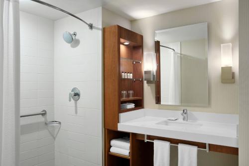 a bathroom with a sink and a mirror at Delta Hotels by Marriott London Armouries in London