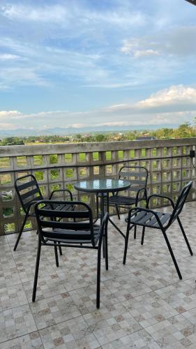 a table and chairs on a patio with a view at โรงแรมมีวาสนา - Me Vadsana Hotel in Ban Thung Yao