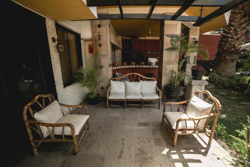 a group of chairs sitting on a patio at Hotel Andenes in Arequipa