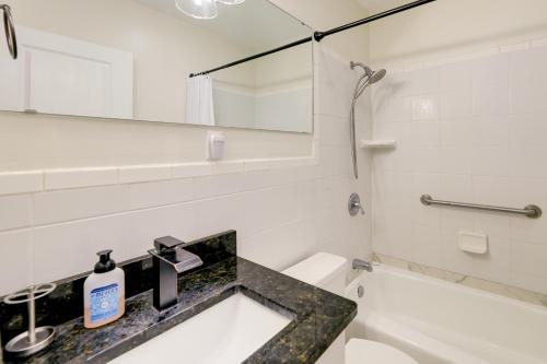 a bathroom with a sink and a toilet and a mirror at North Carolina Retreat - Deck, Grill and Creek Views in Beaufort