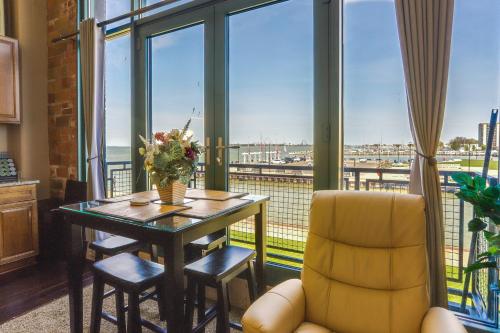 a dining room with a table and a view of the water at Waterfront Sandusky Vacation Rental Downtown! in Sandusky