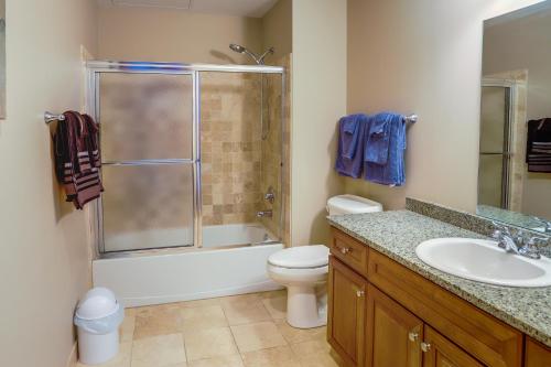 a bathroom with a shower toilet and a sink at Waterfront Sandusky Vacation Rental Downtown! in Sandusky