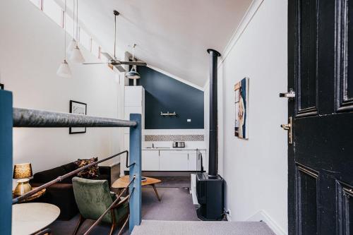 a living room with a staircase and a table at Albert Hotel Daylesford in Daylesford
