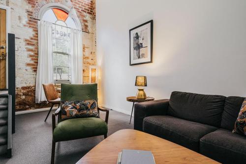 a living room with a couch and a chair at Albert Hotel Daylesford in Daylesford