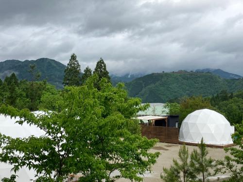 a white dome tent sitting on top of a field at Ｋ&Ｂグランピング　天空の城 in Takeda