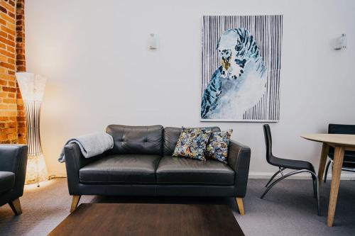 a living room with a couch and a table at Albert Hotel Daylesford in Daylesford