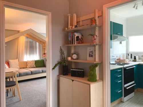 a room with a kitchen and a living room at Central Nest- view & style in Wellington