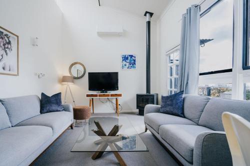 a living room with a couch and a tv at Albert Hotel Daylesford in Daylesford