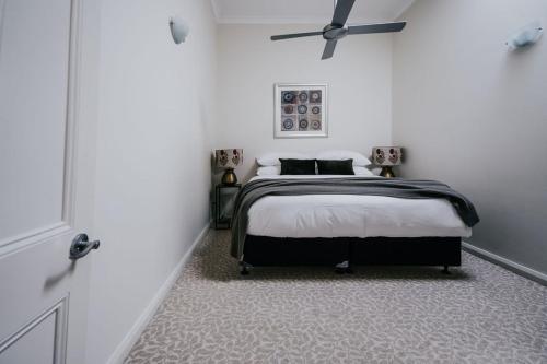 a bedroom with a bed and a ceiling fan at Albert Hotel Daylesford in Daylesford