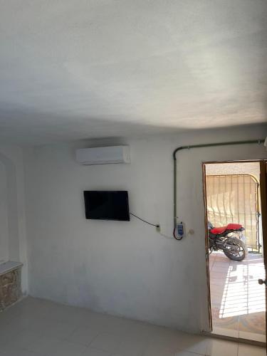 a room with a door and a motorcycle in it at Casa Nova! PRIVATE BATHROOM AND ROOM in Cancún