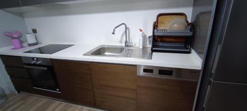 a kitchen with a sink and a counter top at شقة 1+1 in Buyukcekmece