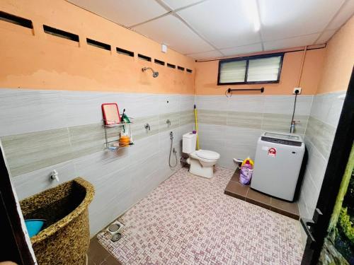 a bathroom with a toilet and a sink at Halim's Rumah Singgah Mxslim only in Jelutong