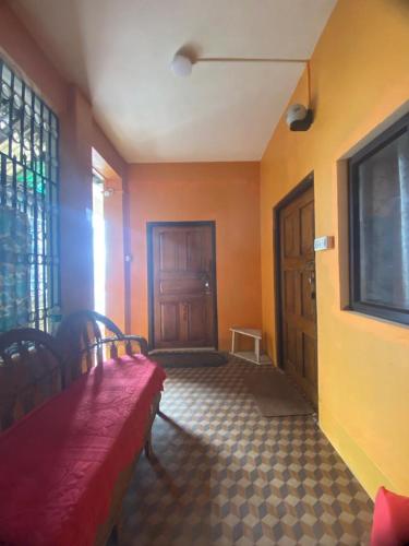 a room with a red bench and a door at MAMTA HOMESTAY in Darjeeling