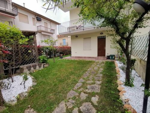 a backyard of a house with a grass yard at La Gabbianella in Marcelli