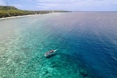 a boat in the water in the ocean at Seascapes Bira in Bira