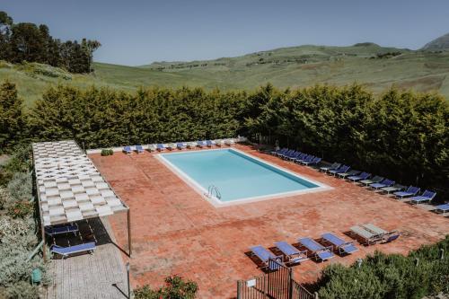 an overhead view of a swimming pool and chairs and trees at Antico Feudo San Giorgio in Polizzi Generosa