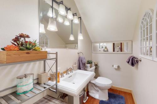 a white bathroom with a sink and a toilet at Pine Lantern Retreat in South Lake Tahoe