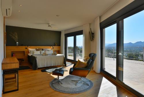 a bedroom with a bed and a desk and a chair at Villa Alegria by NRAS in Albir