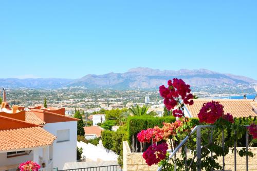 a view of a city with flowers on a building at Villa Alegria by NRAS in Albir