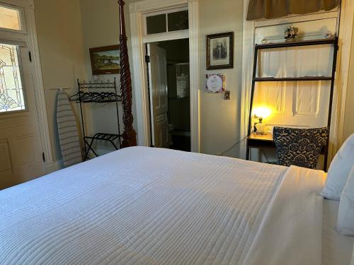 a bedroom with a large white bed in a room at El Amador Inn Downtown Tucson in Tucson