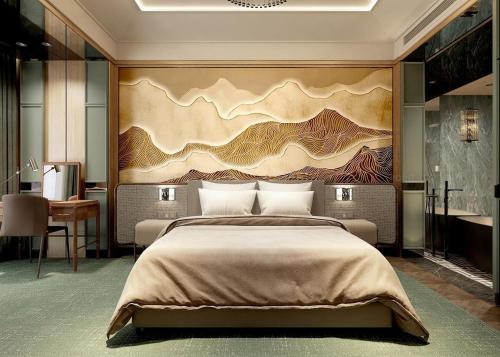 a bedroom with a large bed and a painting on the wall at La Passion Premium Cau Go in Hanoi