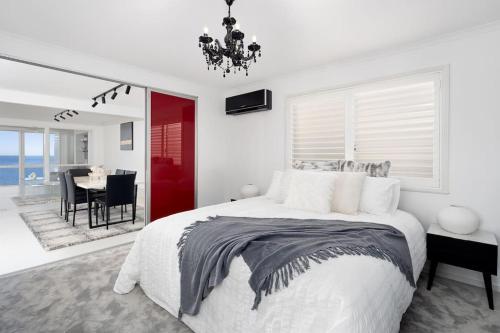 a bedroom with a large bed and a dining room at Scarborough Waterfront Penthouse Unit in Scarborough