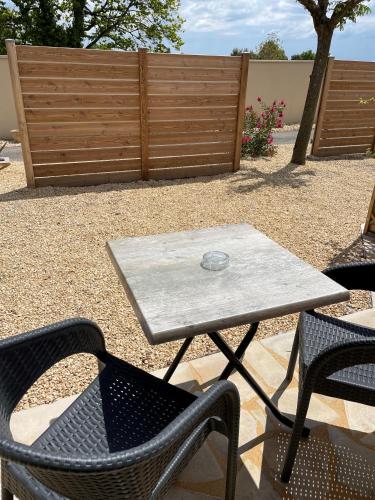a table and two chairs and a table and chairs at Hôtel Le Mas del Pechs - Chambres avec terrasse in Sarlat-la-Canéda
